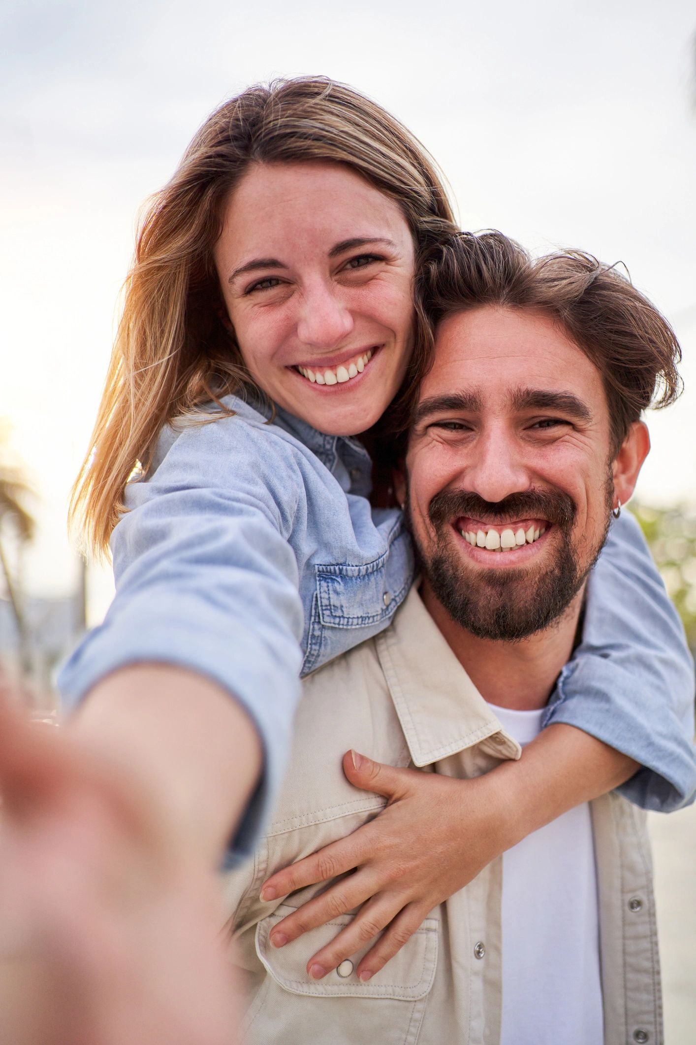 Happy couple taking a selfie together outdoors
